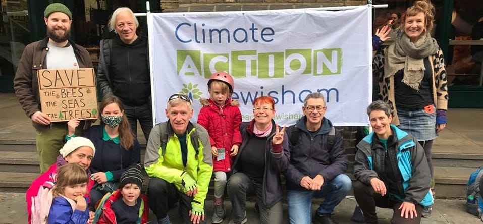 Climate Action Lewisham members and other on a demo with sign